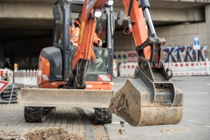 Bagger beim Heben von Erdmaterial auf einer Baustelle